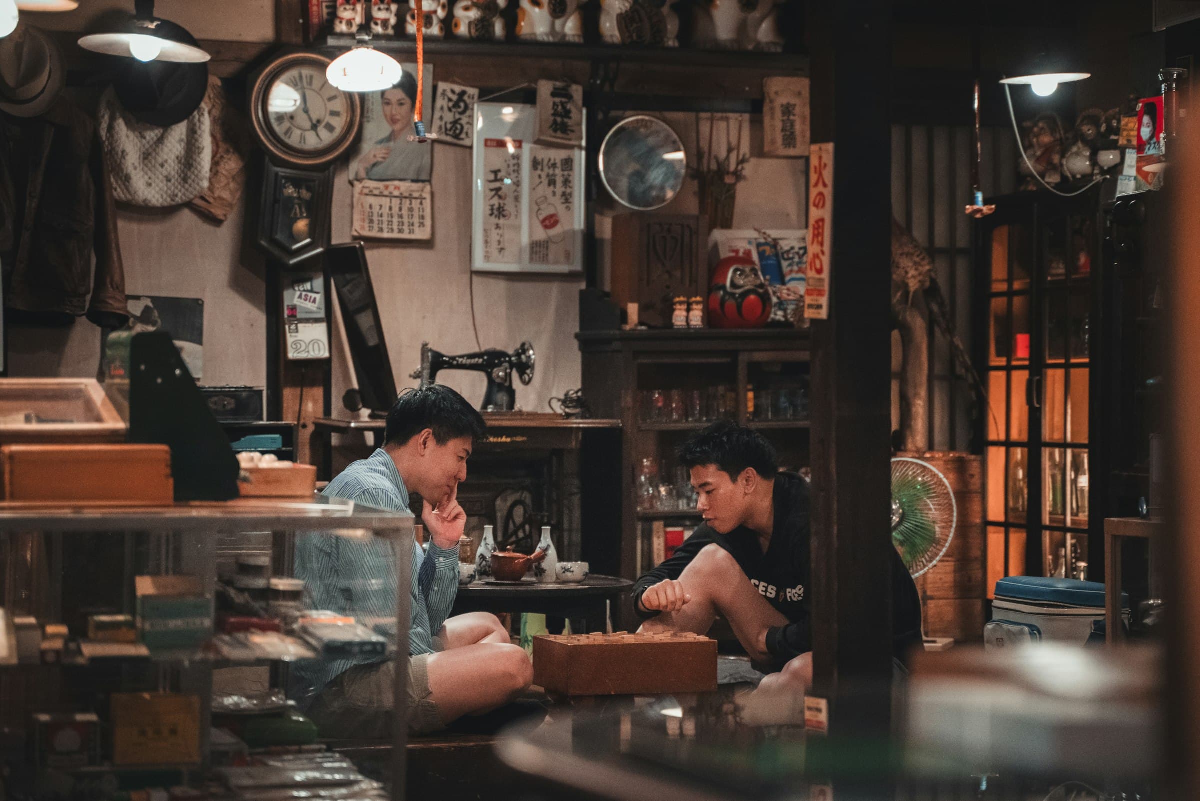 A couple of men sitting at a table in a room